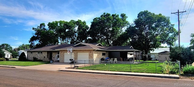ranch-style house featuring a garage, fence, driveway, and a front yard