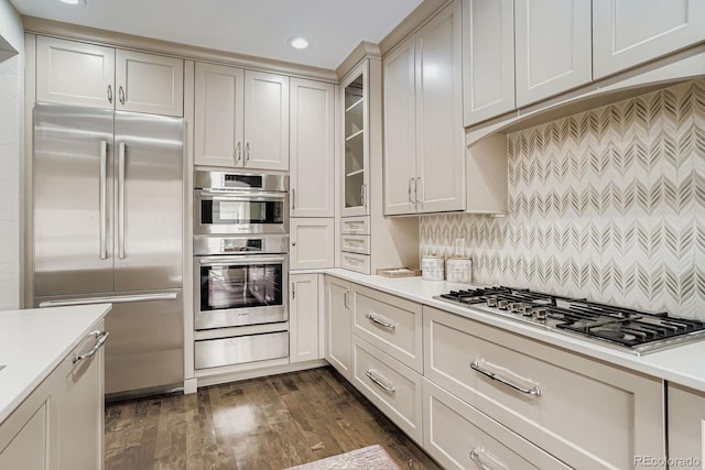 490 Columbine St Unit 5, Denver, CO 80206 - kitchen featuring appliances with stainless steel finishes, a warming drawer, light countertops, recessed lighting, and glass insert cabinets