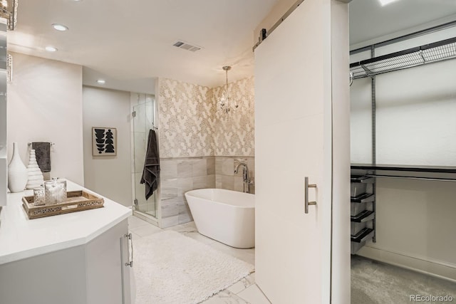490 Columbine St Unit 5, Denver, CO 80206 - full bathroom with recessed lighting, marble look tile flooring, a freestanding tub, a shower stall, and vanity