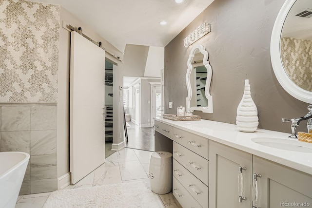 490 Columbine St Unit 5, Denver, CO 80206 - full bath with a soaking tub, double vanity, marble finish flooring, and recessed lighting