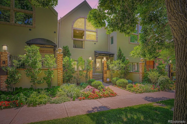 490 Columbine St Unit 5, Denver, CO 80206 - view of front of house with stucco siding, a gate, and a fenced front yard