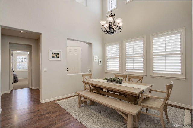 4542 Valleybrook Dr, Highlands Ranch, CO 80130 - dining space with dark wood-style flooring, baseboards, healthy amount of natural light, and a high ceiling