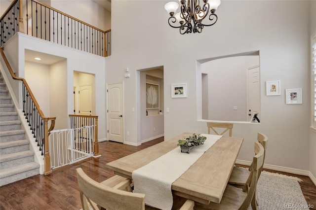 4542 Valleybrook Dr, Highlands Ranch, CO 80130 - dining area featuring a chandelier, wood finished floors, a high ceiling, baseboards, and stairway