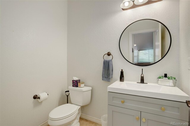 4542 Valleybrook Dr, Highlands Ranch, CO 80130 - bathroom with toilet, vanity, baseboards, and tile patterned flooring