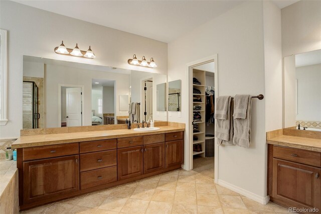 4542 Valleybrook Dr, Highlands Ranch, CO 80130 - ensuite bathroom with a shower stall, vanity, a walk in closet, and tile patterned flooring