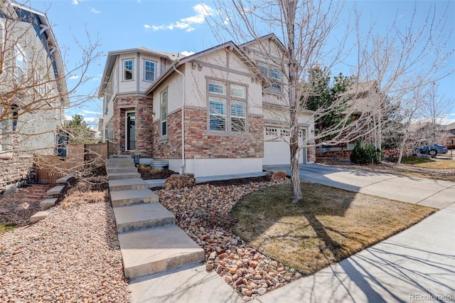 4542 Valleybrook Dr, Highlands Ranch, CO 80130 - view of front of property featuring stone siding, driveway, stucco siding, a garage, and fence