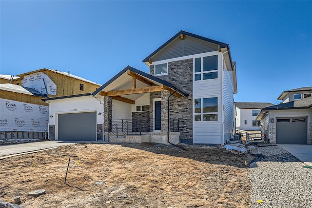 view of front of property featuring covered porch, stone siding, concrete driveway, and an attached garage