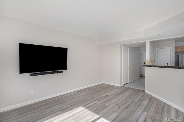 18954 E 57th Pl Unit D, Denver, CO 80249 - unfurnished living room featuring light wood finished floors and recessed lighting