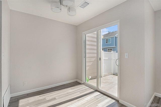 18954 E 57th Pl Unit D, Denver, CO 80249 - unfurnished room featuring light wood-style flooring and a chandelier