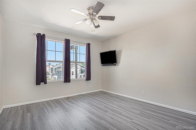 18954 E 57th Pl Unit D, Denver, CO 80249 - spare room featuring dark wood-style flooring and ceiling fan