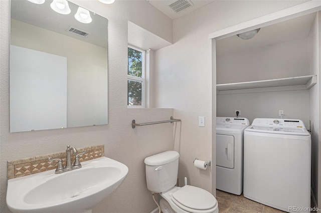 18954 E 57th Pl Unit D, Denver, CO 80249 - half bathroom featuring washer and clothes dryer and tile patterned flooring