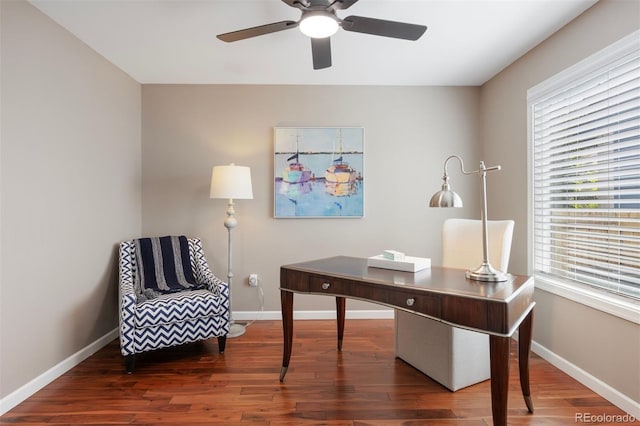 office space featuring wood finished floors, baseboards, a ceiling fan, and healthy amount of natural light