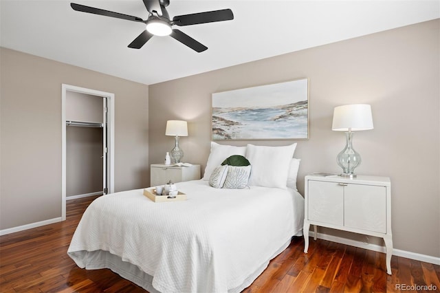 bedroom with hardwood / wood-style floors, baseboards, and a closet