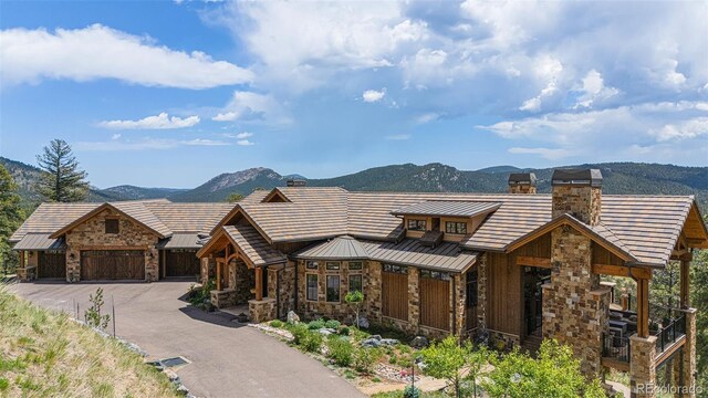 view of front facade featuring a mountain view and a garage