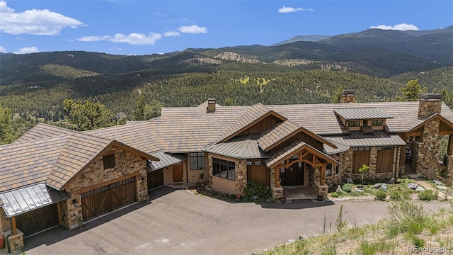 view of front of property with a mountain view and a garage