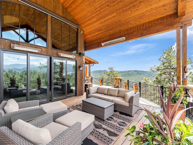 wooden deck with a mountain view and an outdoor hangout area