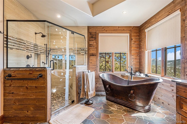 bathroom with wood walls and independent shower and bath