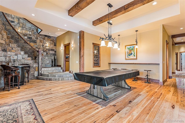 recreation room with beam ceiling, pool table, and light hardwood / wood-style flooring