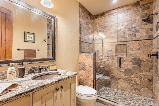 bathroom with vanity, toilet, and an enclosed shower