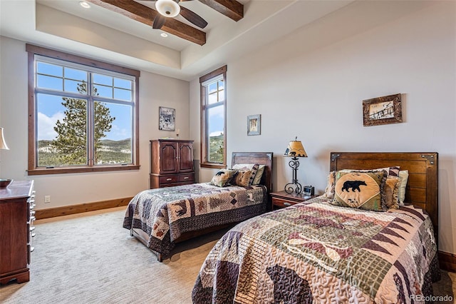 bedroom with ceiling fan and beamed ceiling