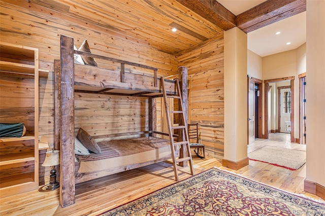 unfurnished bedroom featuring a high ceiling and light wood-type flooring