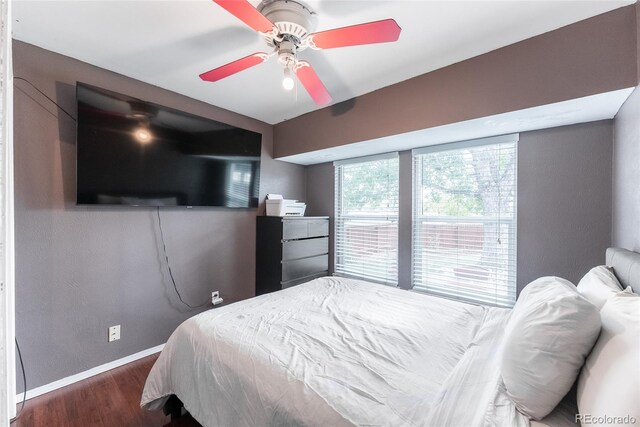 bedroom with ceiling fan and dark hardwood / wood-style floors