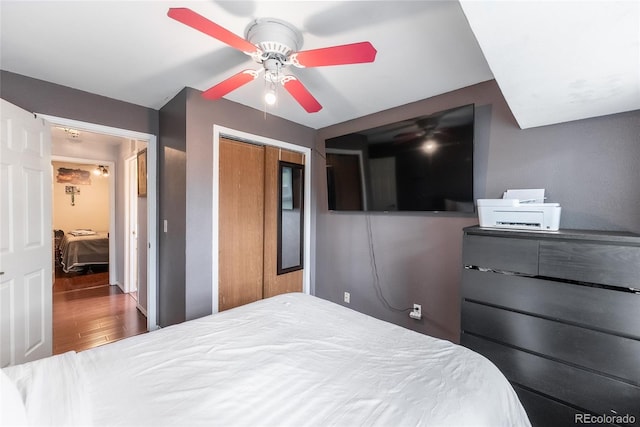 bedroom featuring a closet, hardwood / wood-style flooring, and ceiling fan