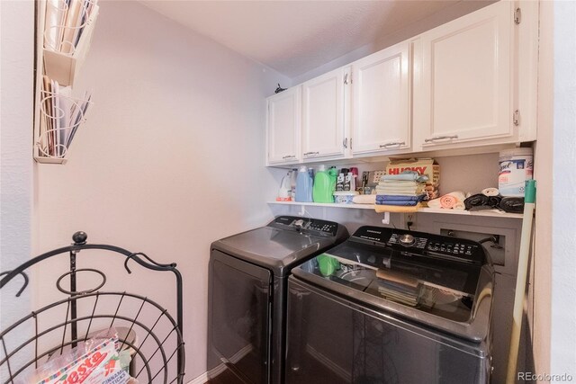 laundry room with cabinets and washing machine and clothes dryer