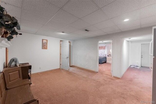 interior space with a paneled ceiling