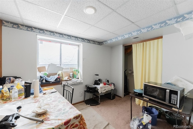 office space with a drop ceiling and light carpet