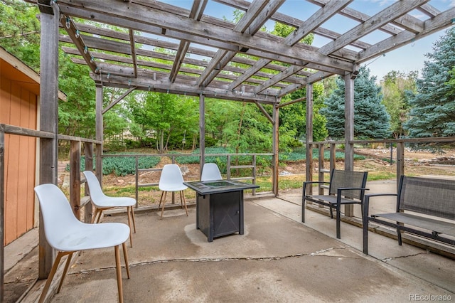 view of patio with a pergola and a fire pit