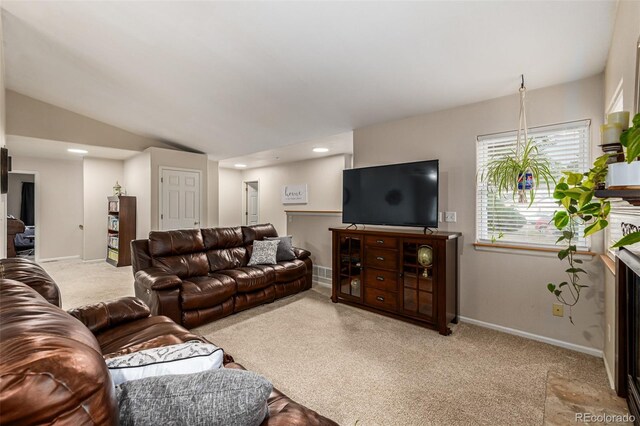 carpeted living room featuring vaulted ceiling