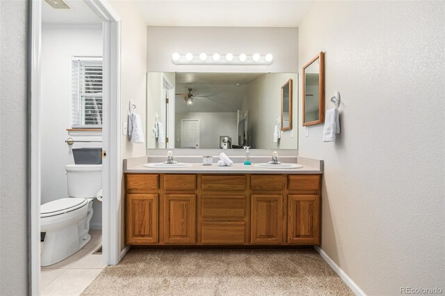 bathroom with vanity, ceiling fan, tile patterned flooring, and toilet