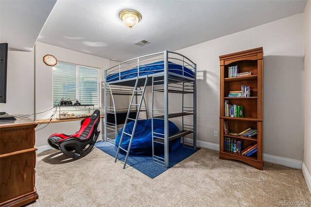 bedroom featuring carpet floors and a textured ceiling