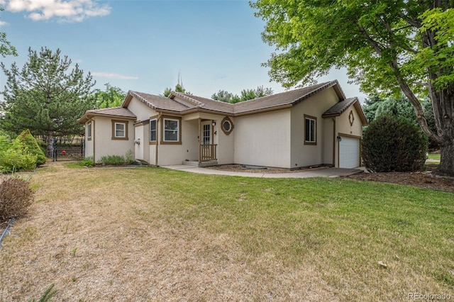 view of front of property with a garage and a front yard