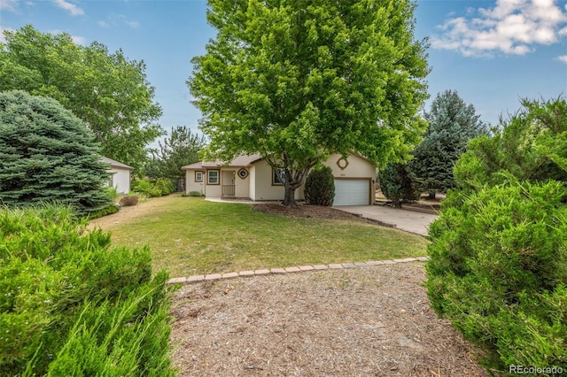 obstructed view of property featuring a garage and a front yard