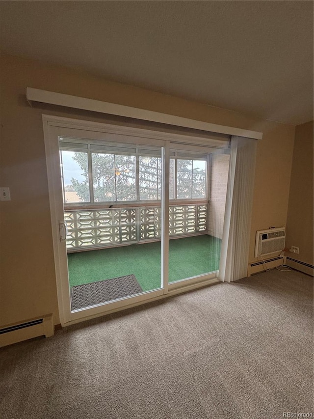 unfurnished room with carpet floors, an AC wall unit, and baseboard heating