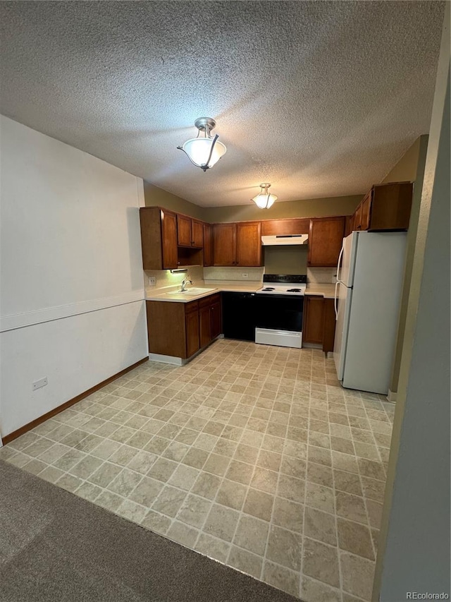 kitchen with a textured ceiling, electric range oven, light countertops, baseboards, and freestanding refrigerator