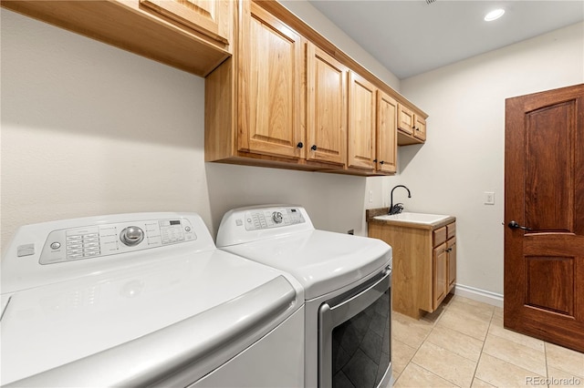 laundry area with washing machine and dryer, cabinets, light tile patterned flooring, and sink