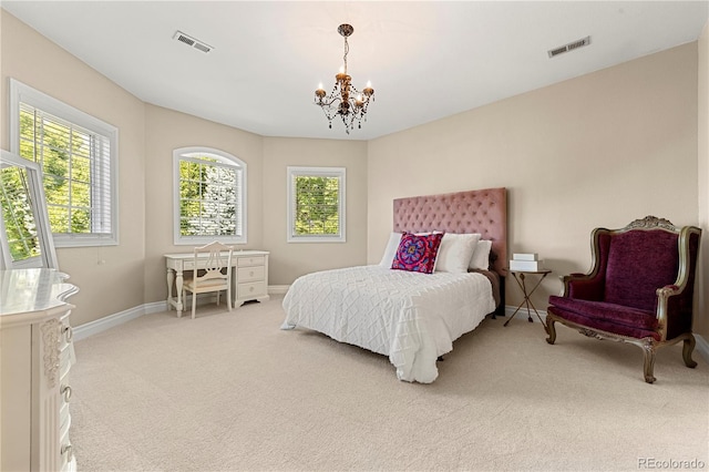 carpeted bedroom with an inviting chandelier