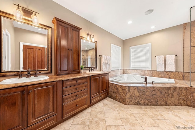 bathroom featuring vanity and tiled tub