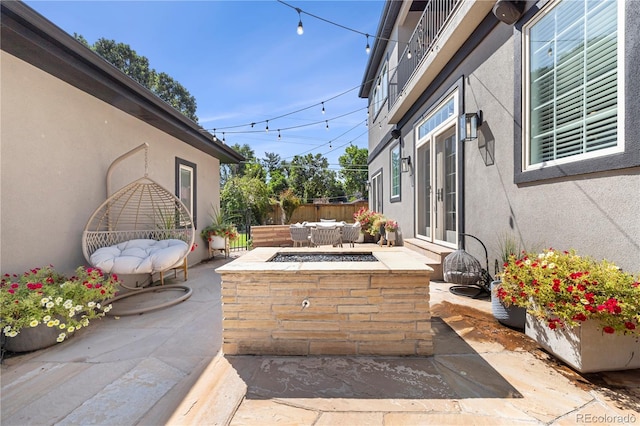 view of patio / terrace featuring an outdoor fire pit