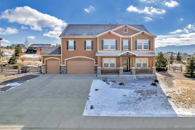 craftsman-style home featuring a mountain view, a garage, and covered porch