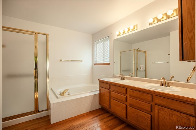 bathroom with separate shower and tub, hardwood / wood-style flooring, and vanity