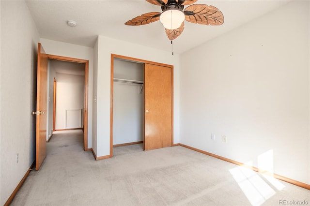 unfurnished bedroom with light carpet, a closet, and ceiling fan