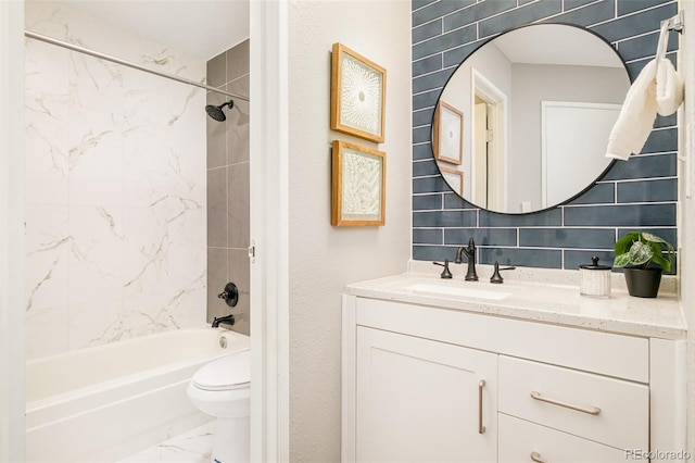 full bathroom featuring tile walls, tasteful backsplash, toilet, vanity, and tiled shower / bath combo