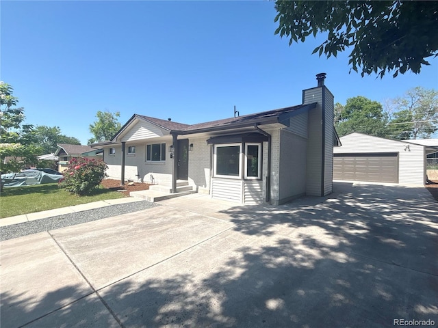 8239 Nola Dr, Denver, CO 80221 - ranch-style home featuring an outbuilding, a detached garage, a chimney, and brick siding