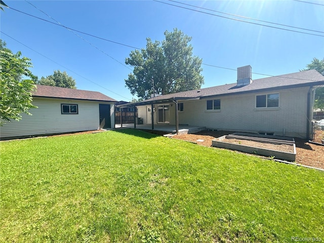 8239 Nola Dr, Denver, CO 80221 - rear view of house with a lawn and an outdoor structure