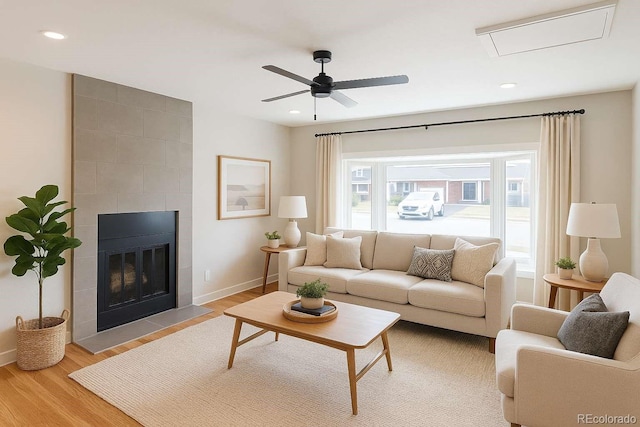 8239 Nola Dr, Denver, CO 80221 - living area featuring light wood finished floors, ceiling fan, a tile fireplace, and recessed lighting
