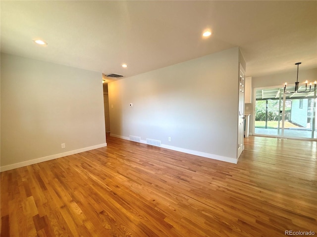 8239 Nola Dr, Denver, CO 80221 - unfurnished room featuring a chandelier, light wood-type flooring, and recessed lighting
